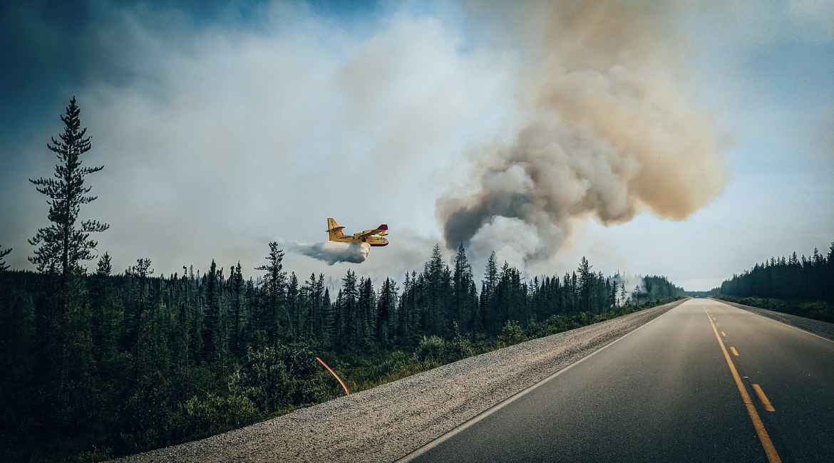 Water bomber aircraft drops water on a forest wildfire in La Grande Rivière, Quebec. 